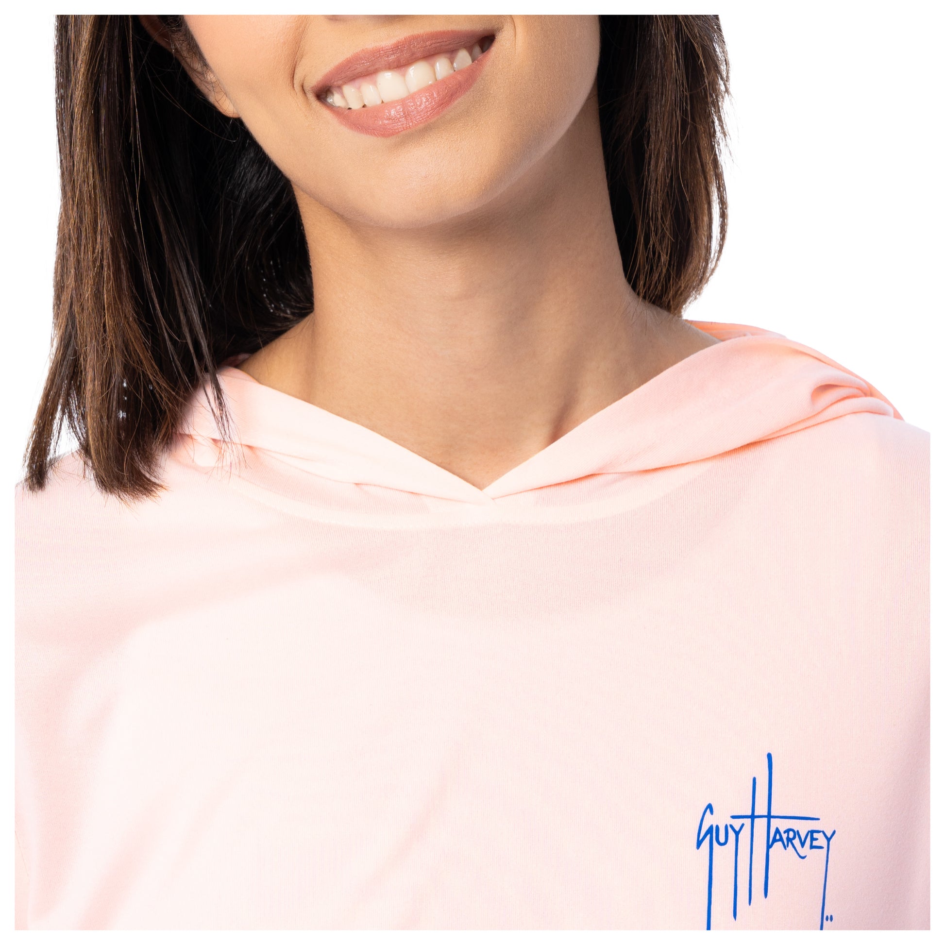 Close-up of a person wearing a pink hoodie with 'Guy Harvey' logo.