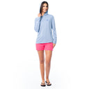 Woman wearing a light blue hoodie and pink shorts on a white background