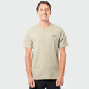 A man wearing a light heather gray t-shirt with a small blue Guy Harvey logo on the left chest, photographed against a solid light gray background.