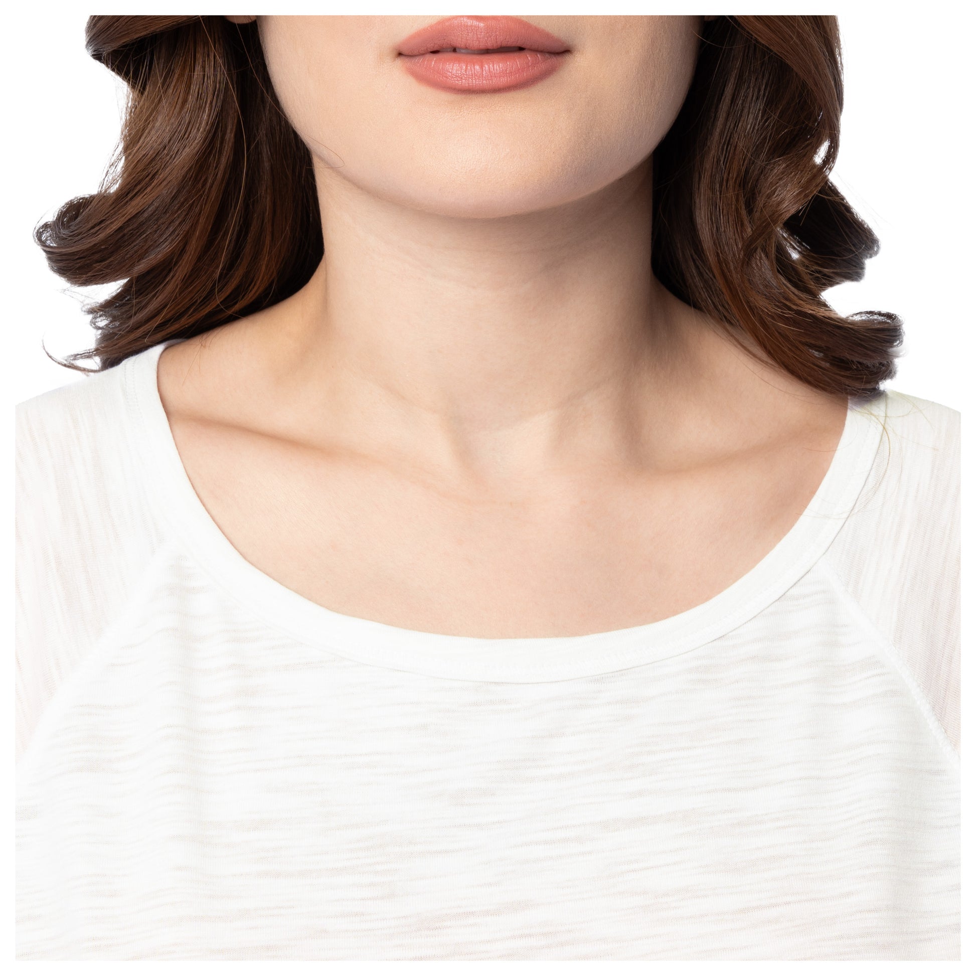 Close-up of a person wearing a white top with a blurred background