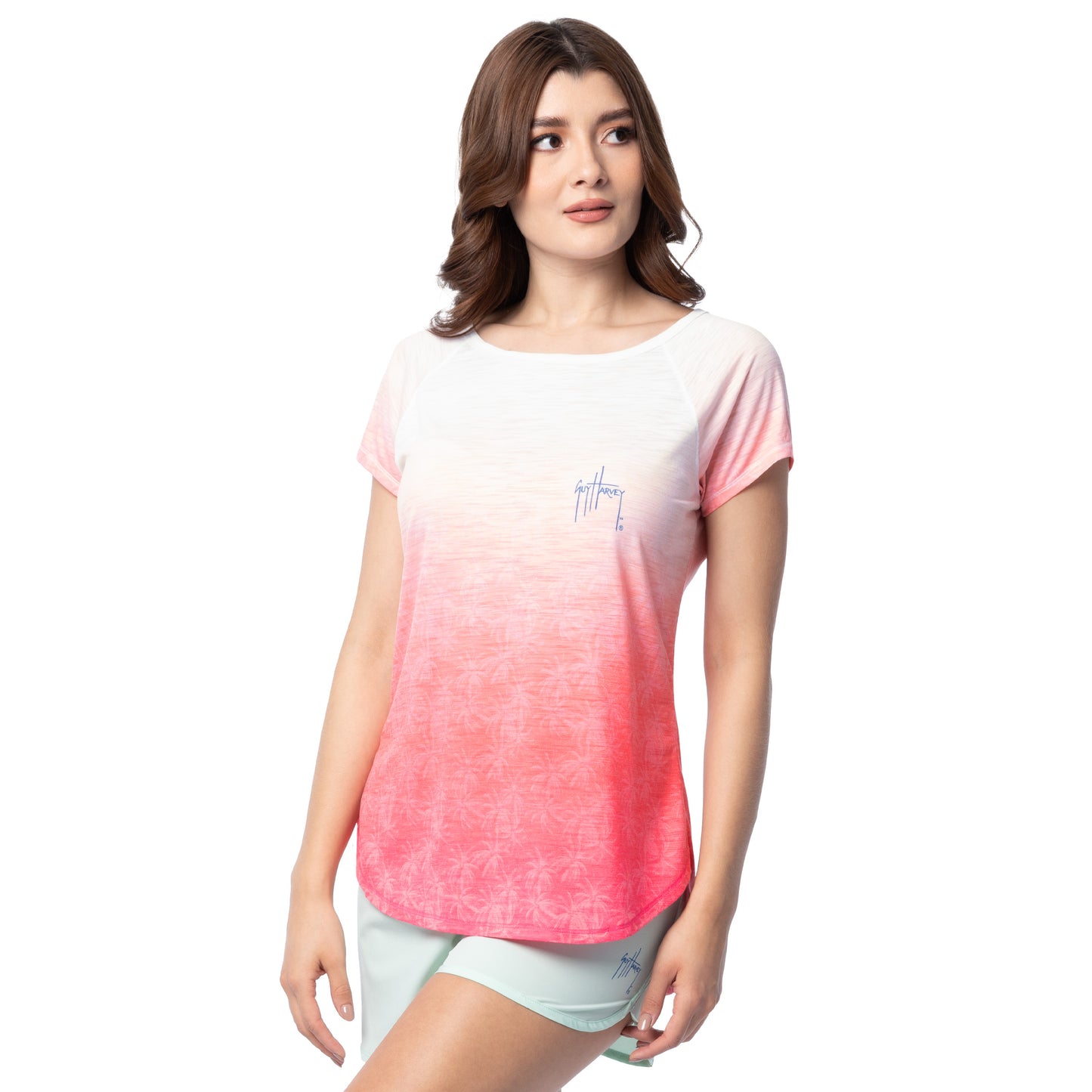 Woman wearing a gradient t-shirt with a Guy Harvey signature logo on a white background