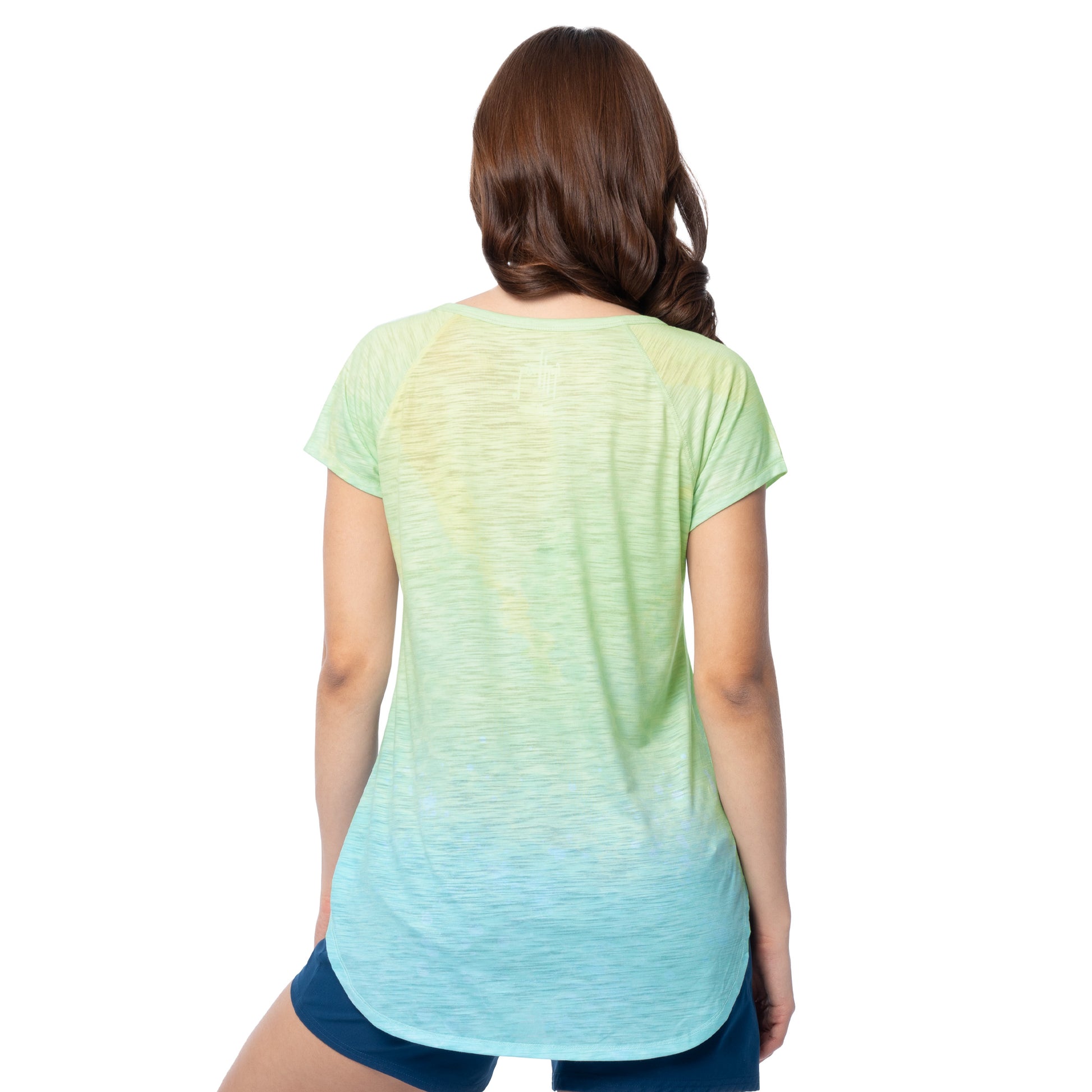Woman wearing a green to blue gradient t-shirt on a white background