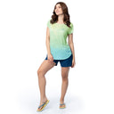 Woman wearing a gradient t-shirt and shorts on a white background