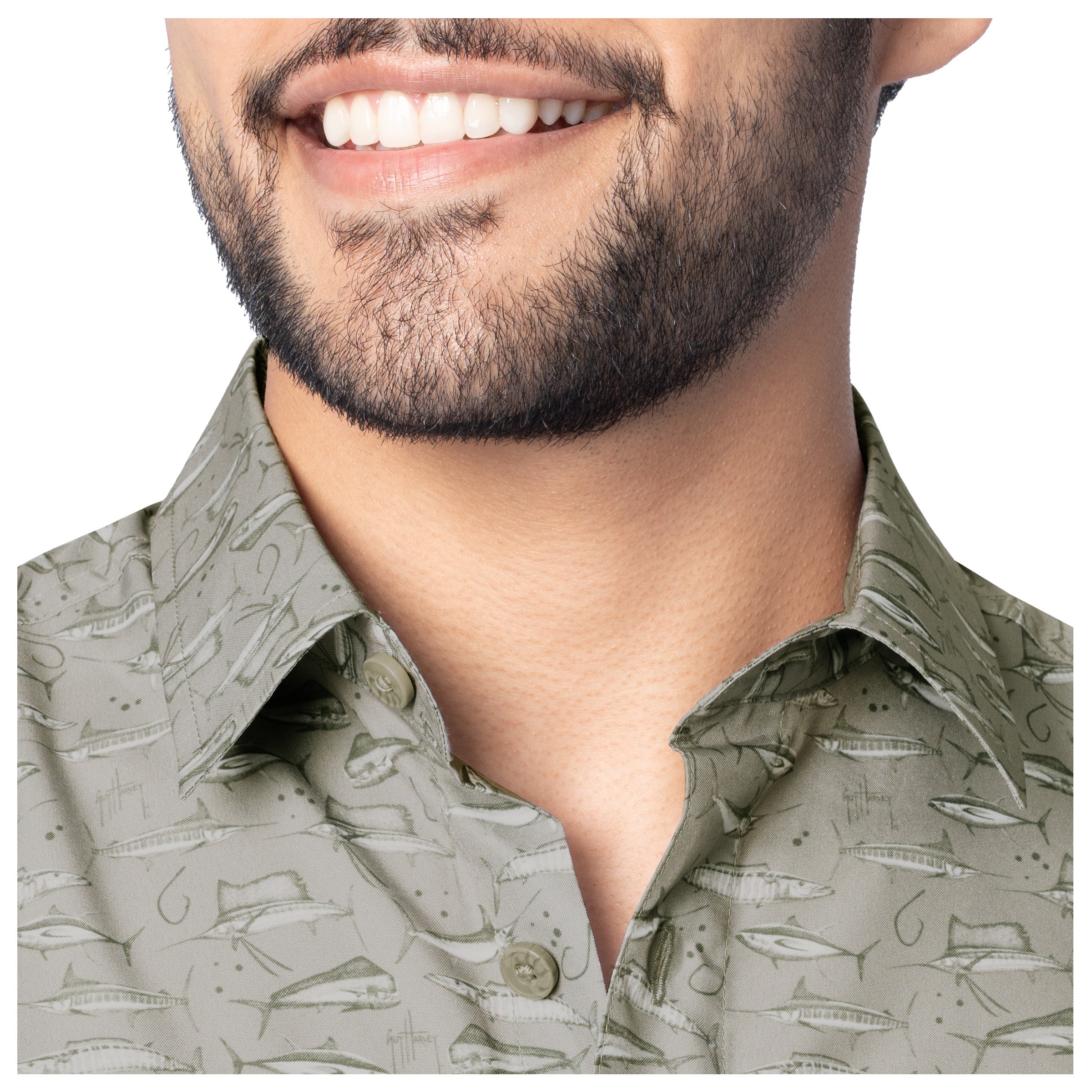 Man wearing a patterned shirt with a neutral background