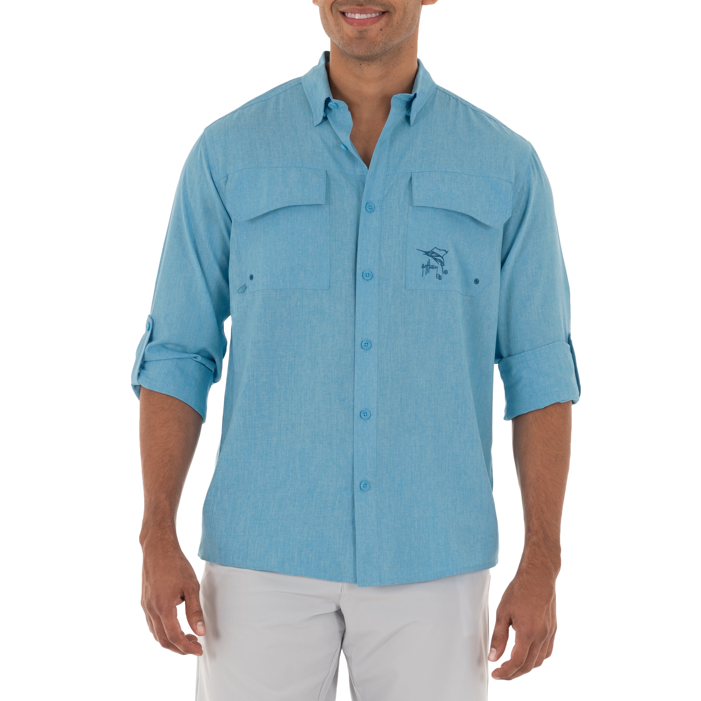 Man wearing a light blue button-up shirt with a logo on a white background