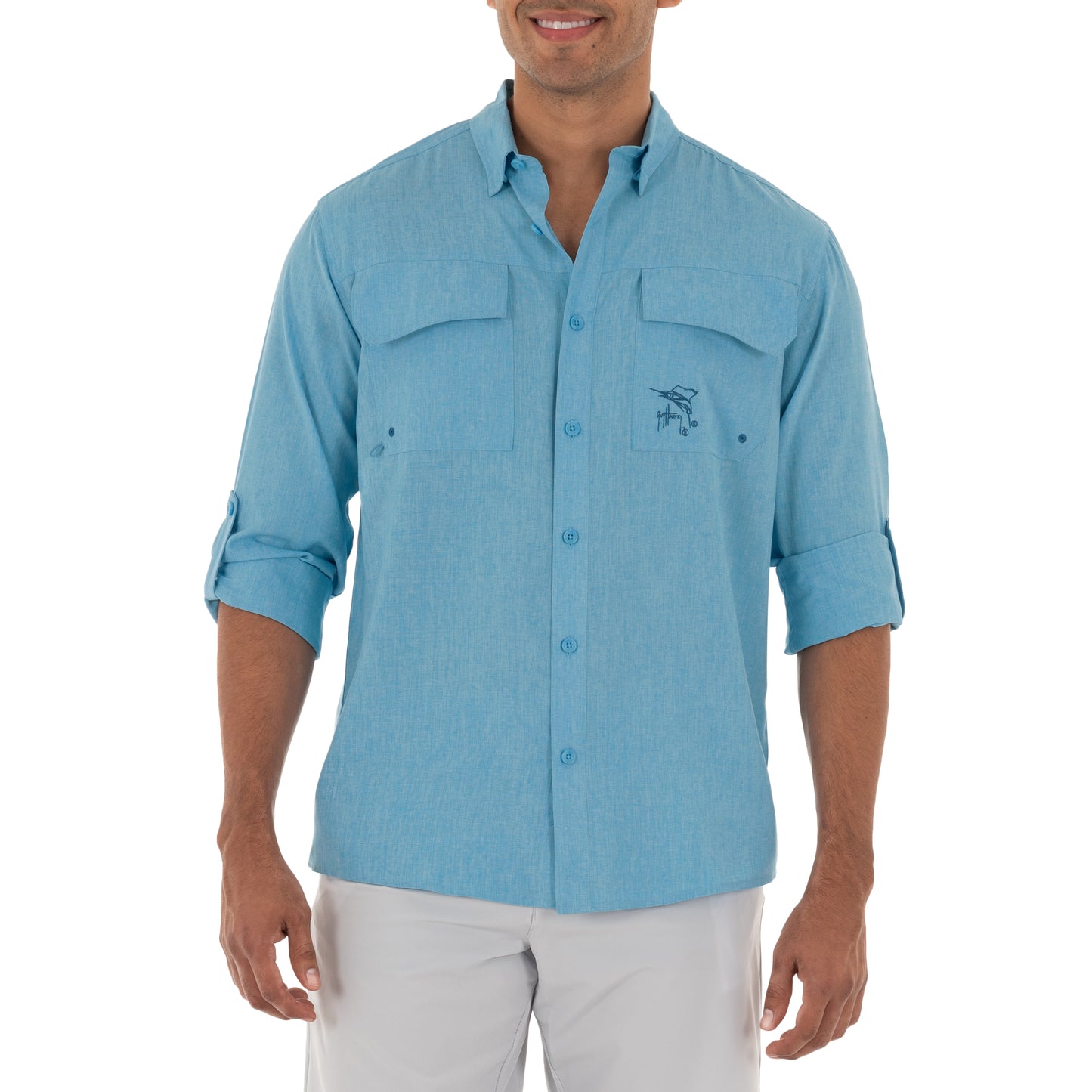 Man wearing a light blue button-up shirt with a logo on a white background