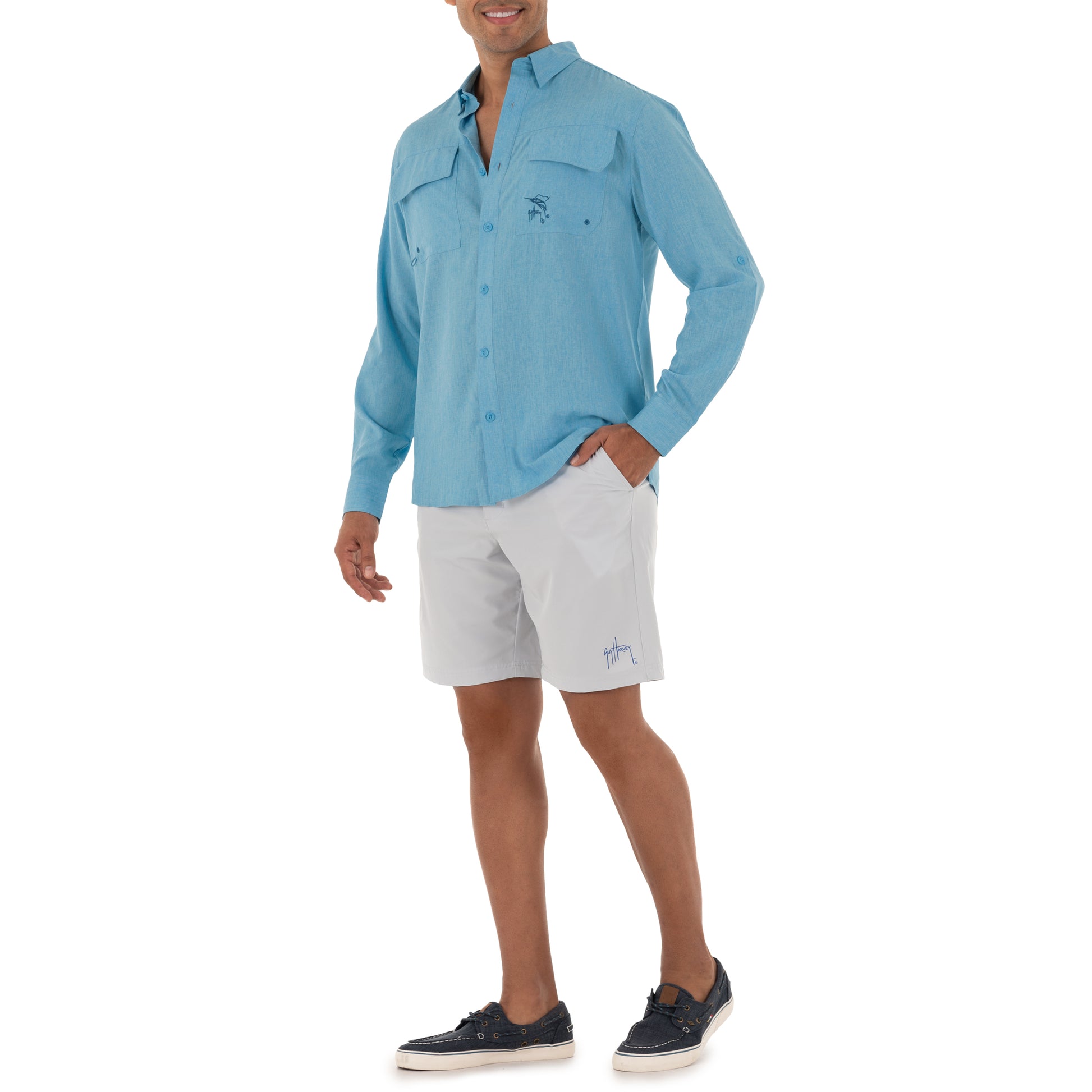 Person wearing a blue shirt and white shorts on a white background