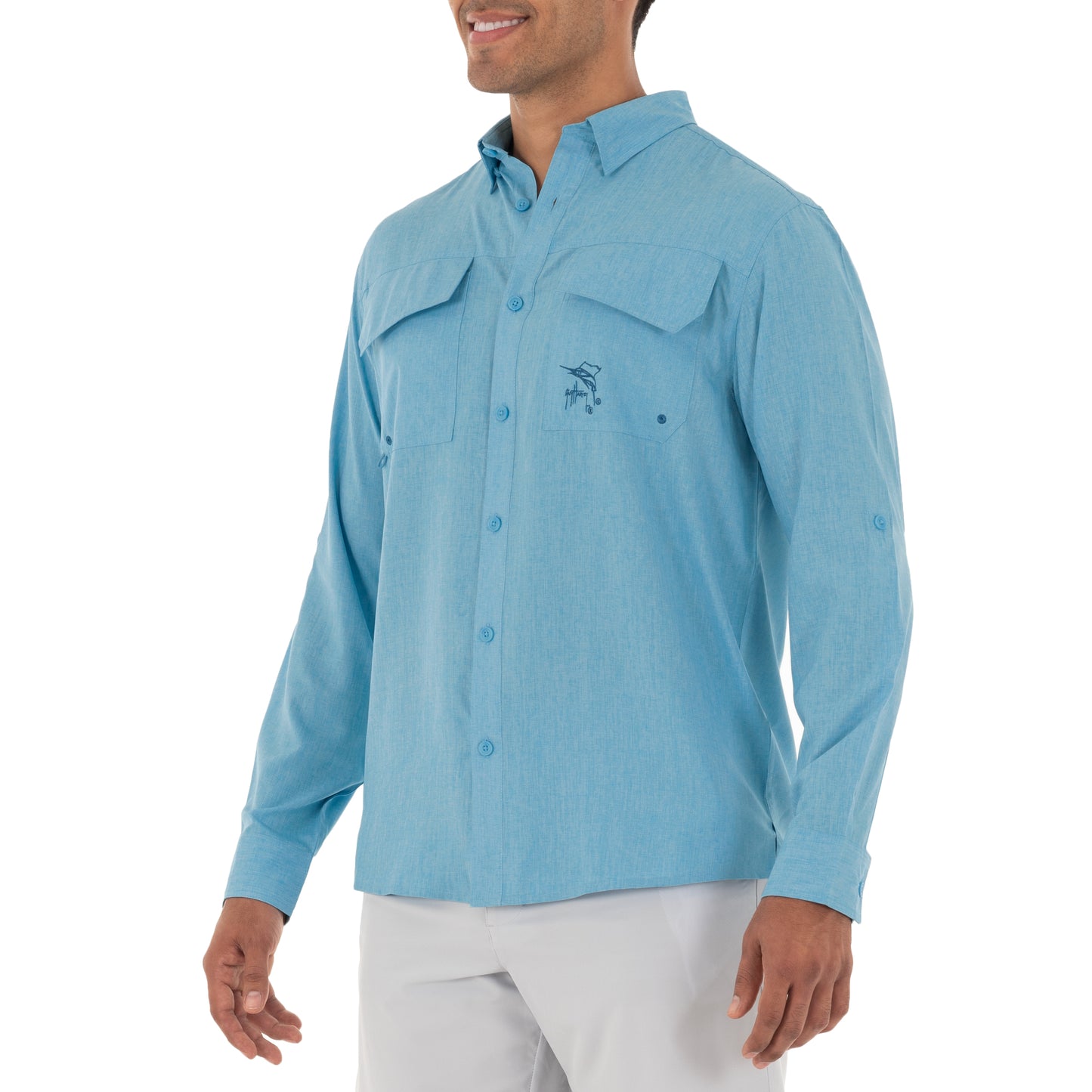 Man wearing a light blue button-up shirt with a logo on a white background