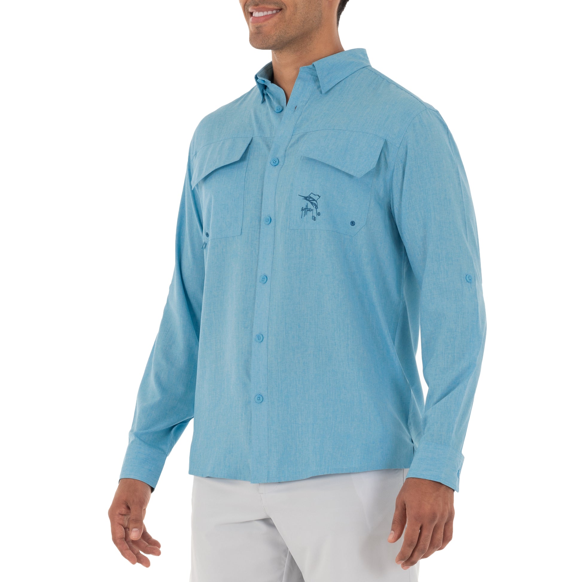 Man wearing a light blue button-up shirt with a logo on a white background