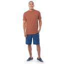 Man wearing a brown t-shirt and blue shorts on a white background