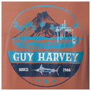 Guy Harvey logo on a brown background with Volcano, palm trees, and fish design.