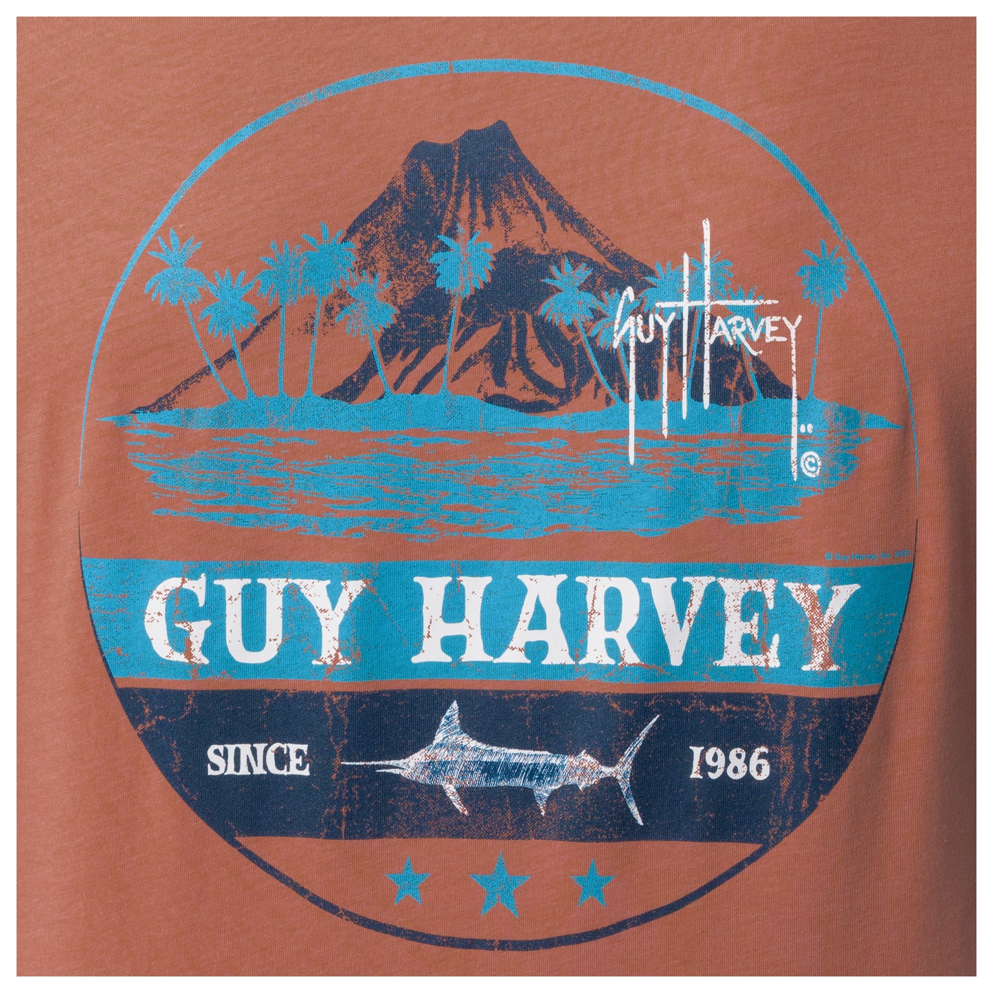 Guy Harvey logo on a brown background with Volcano, palm trees, and fish design.