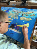 Guy Harvey painting an underwater scene