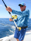 A man with a fishing reel smiling