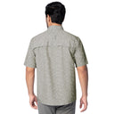 Man wearing a patterned gray shirt on a white background