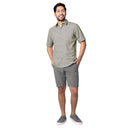 Man wearing a gray patterned shirt and shorts on a white background