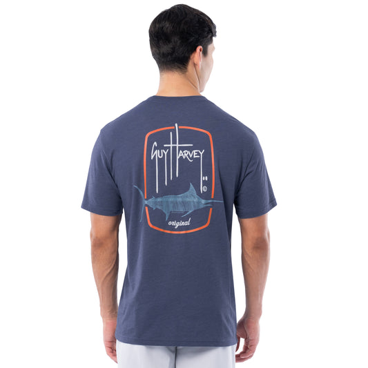 Man wearing a navy Guy Harvey t-shirt with a marlin graphic on the back.