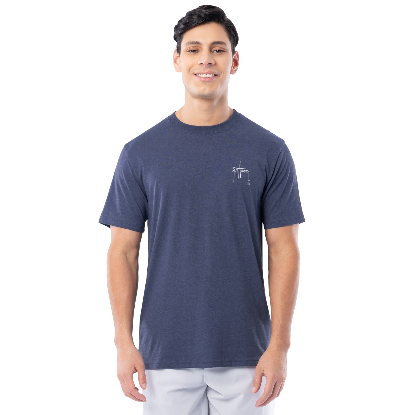 Man wearing a navy blue t-shirt with a Guy Harvey logo on a white background
