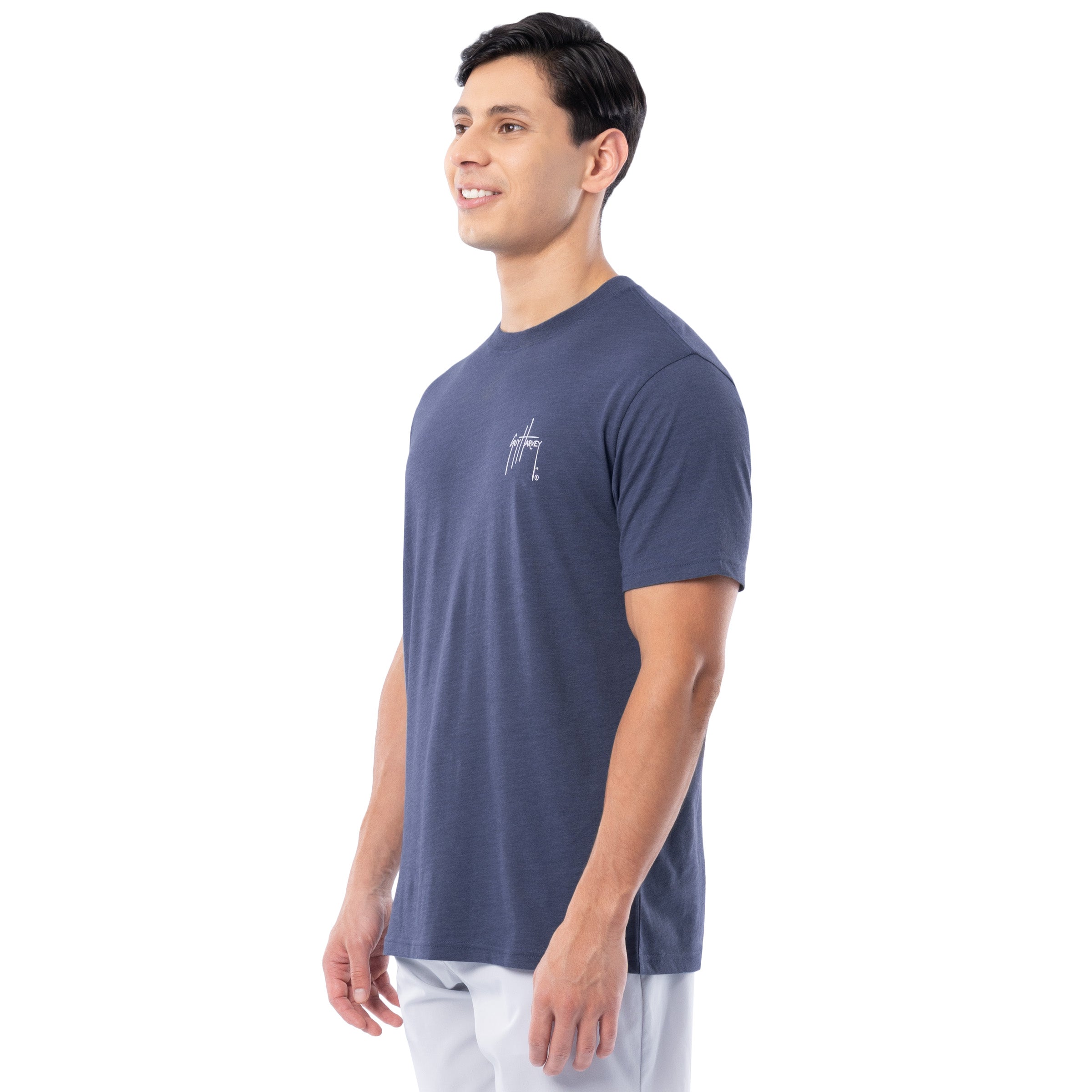 Man wearing a navy blue t-shirt with a logo on a white background