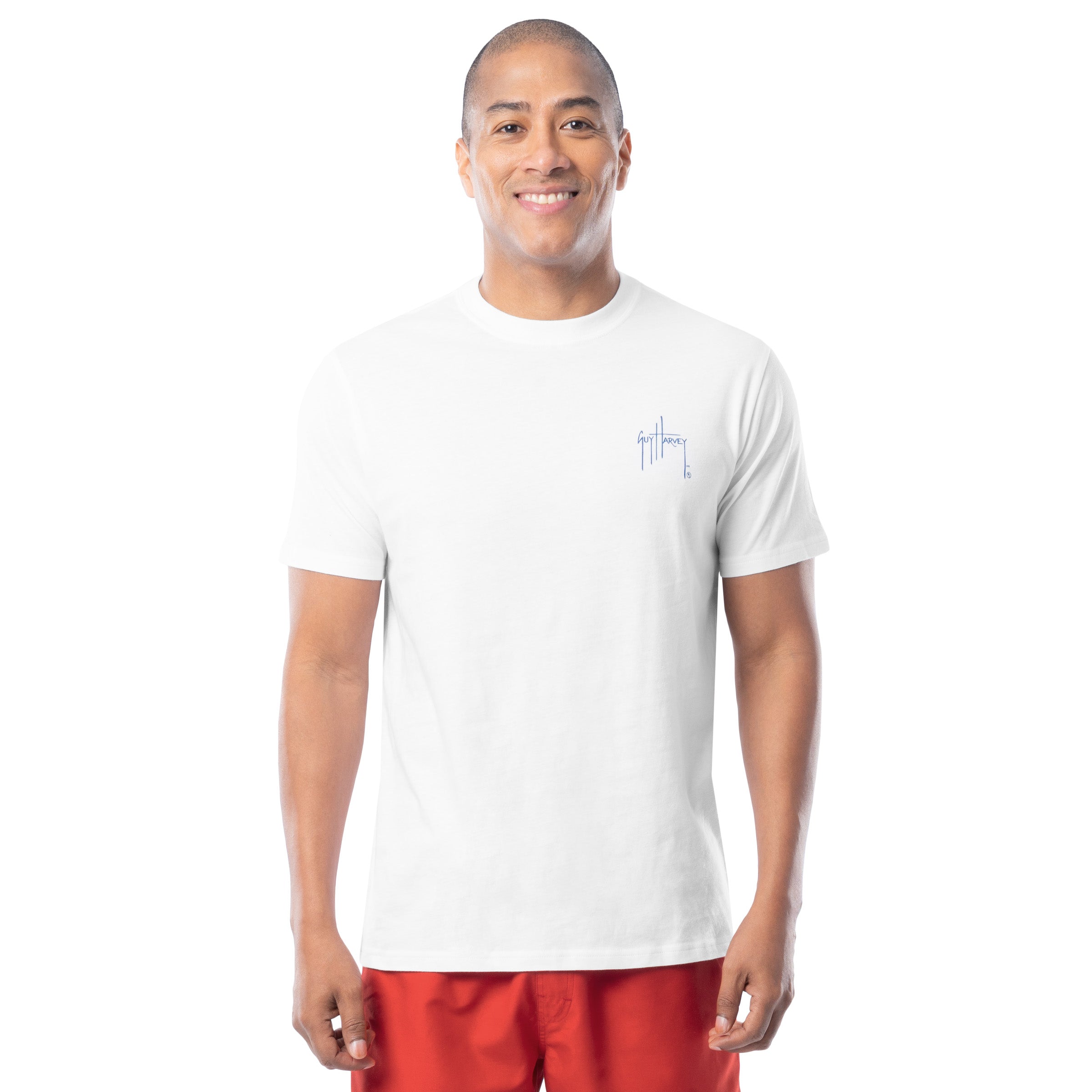 Man wearing a white t-shirt with a small logo on a white background