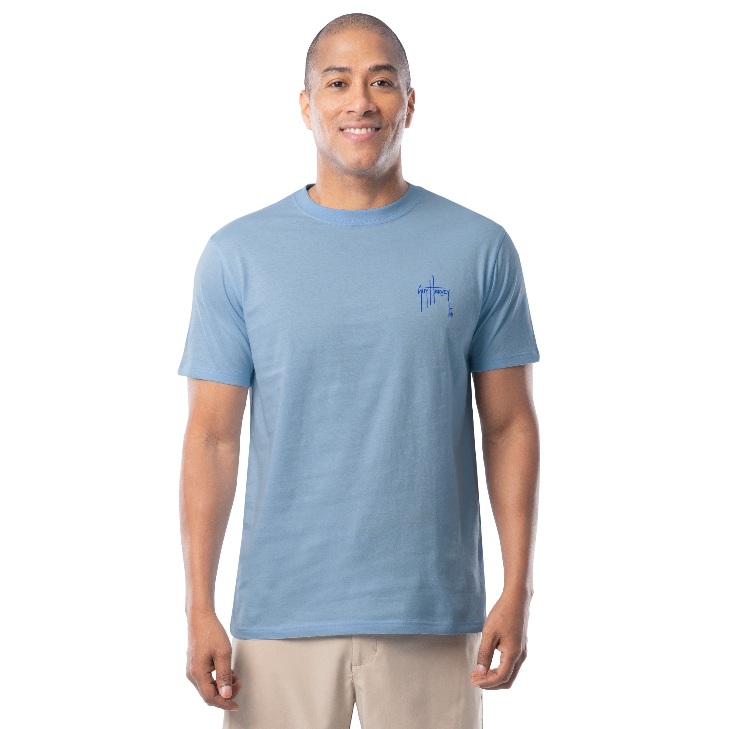 Man wearing a light blue t-shirt with a Guy Harvey logo on a white background