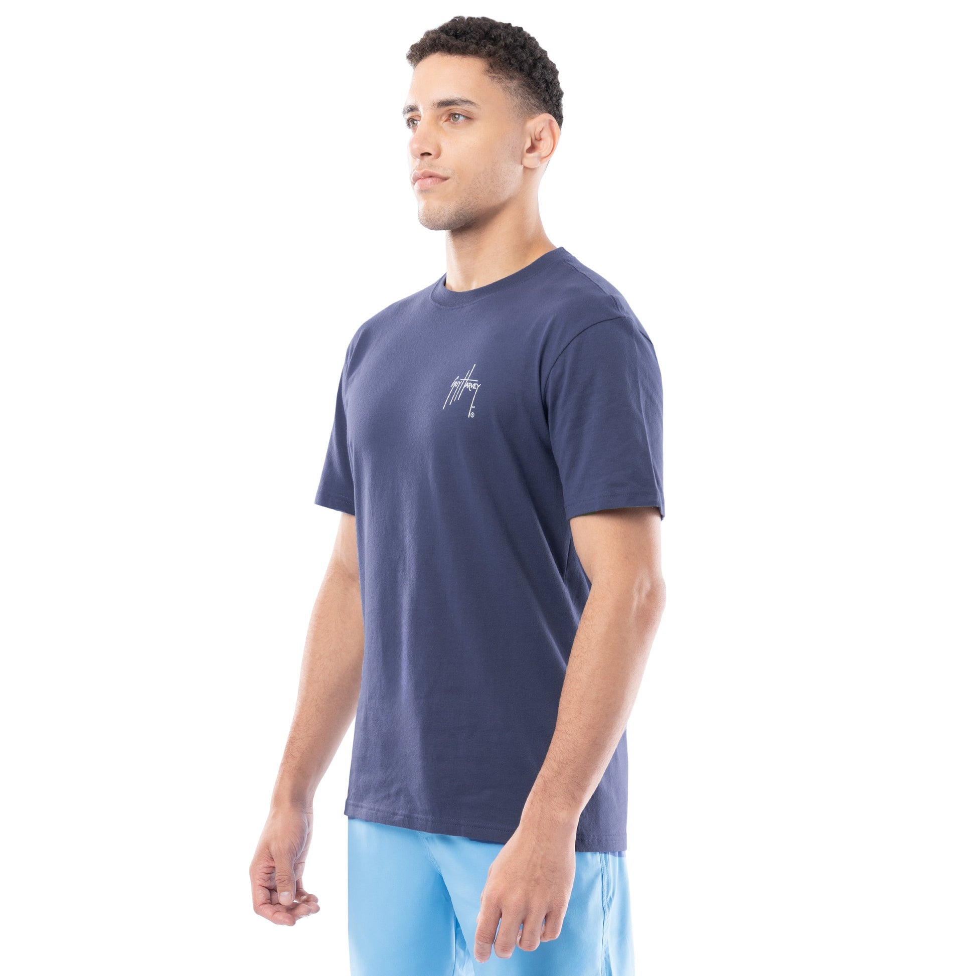 Man wearing a navy blue t-shirt with a logo on a white background