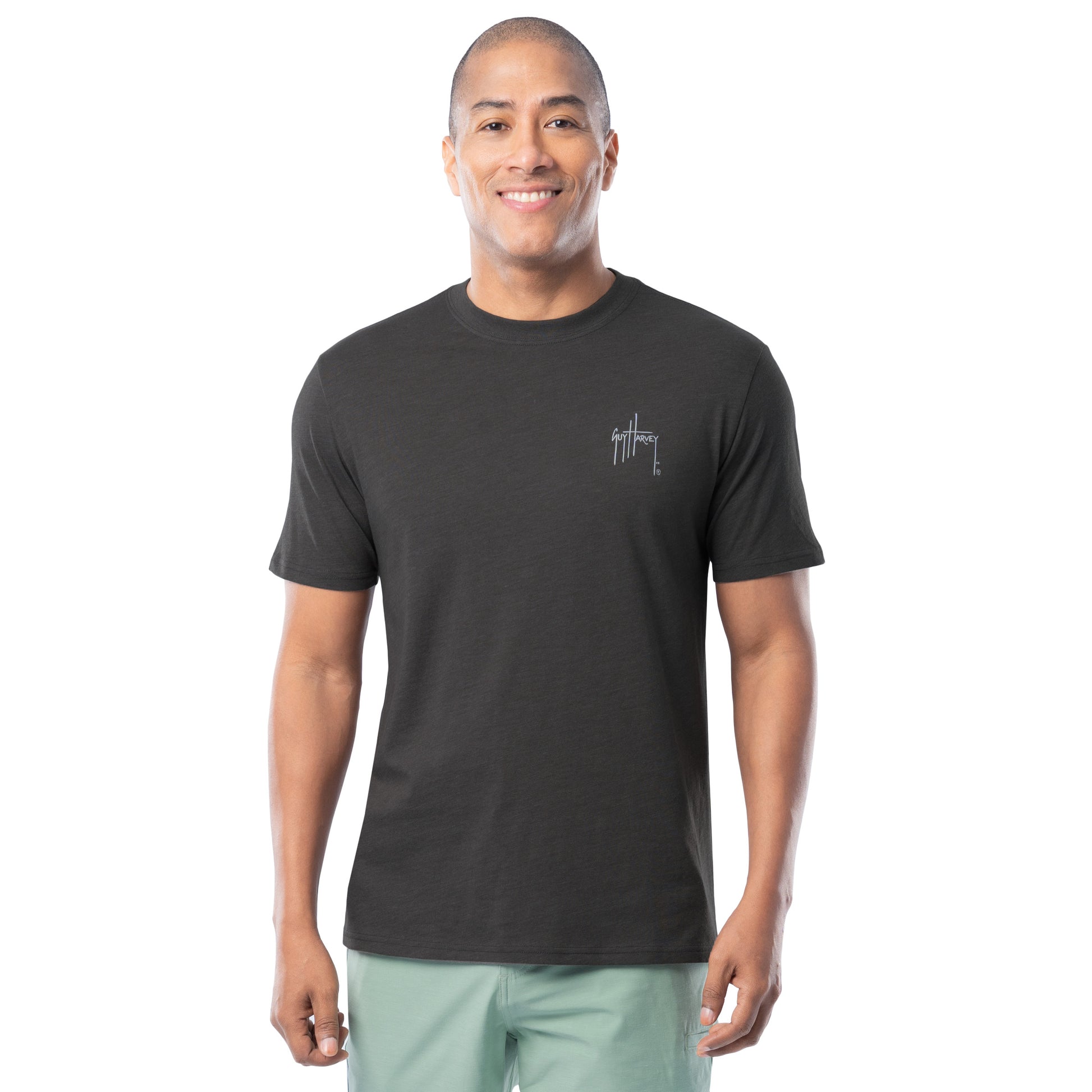 Man wearing a black t-shirt with a Guy Harvey logo on a white background