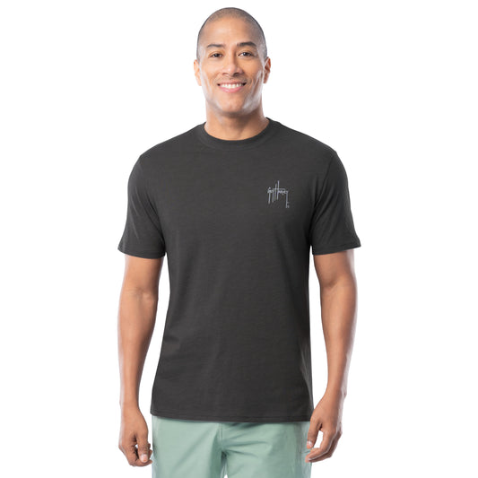 Man wearing a black t-shirt with a Guy Harvey logo on a white background