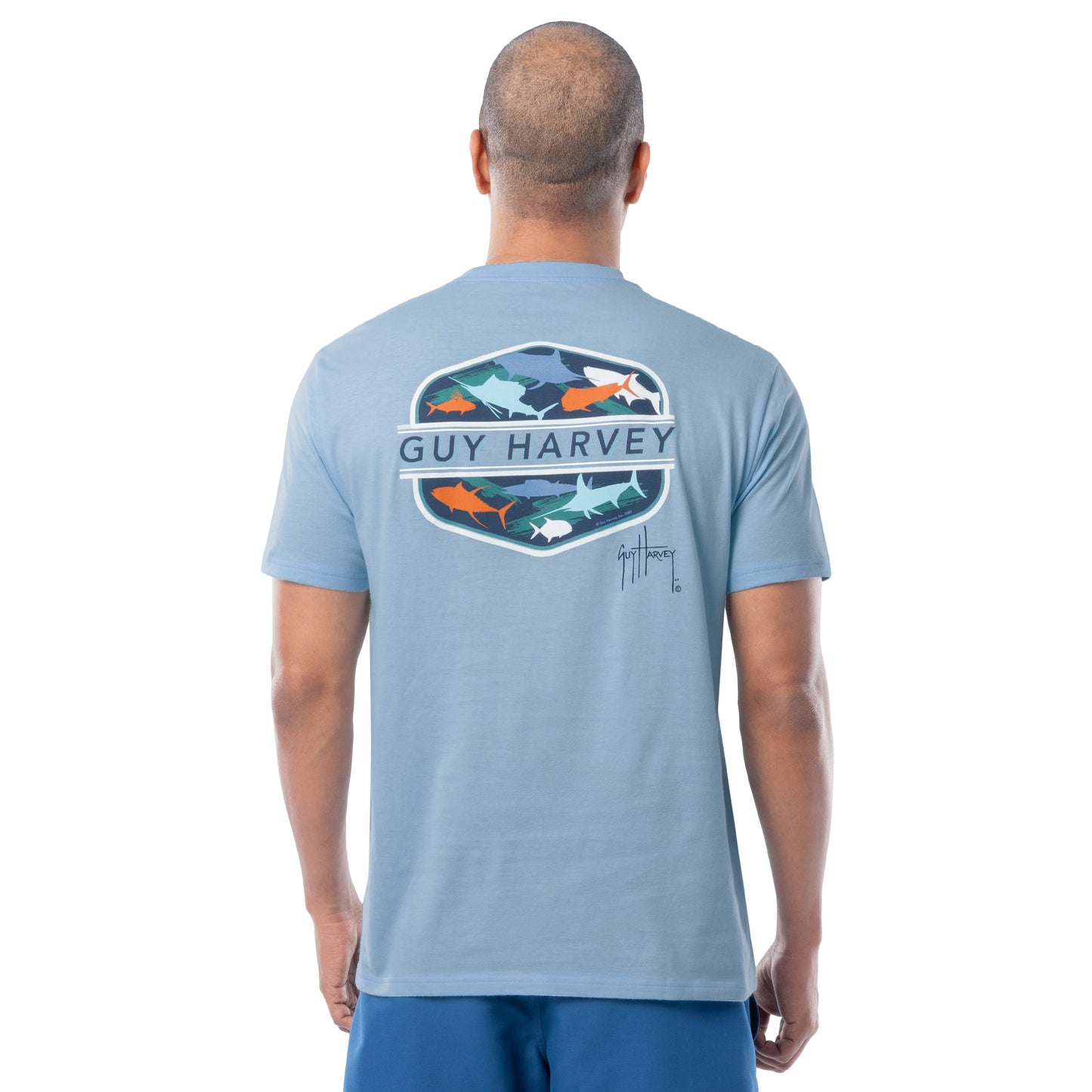 Man wearing a Guy Harvey t-shirt with a graphic design on the back featuring many salt water species against a white background