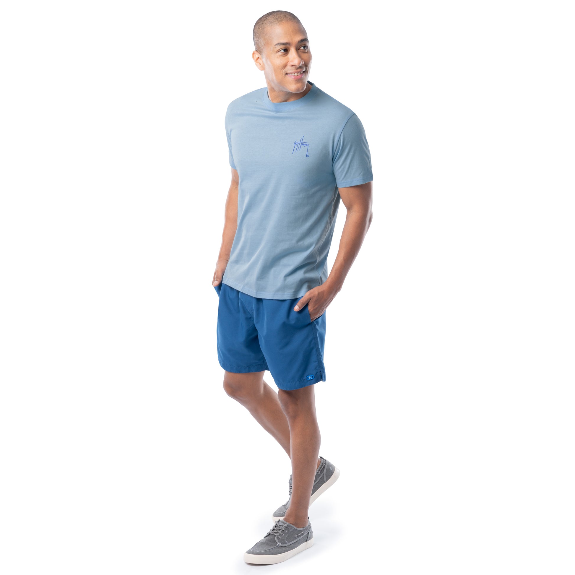 Man wearing a blue t-shirt and shorts on a white background
