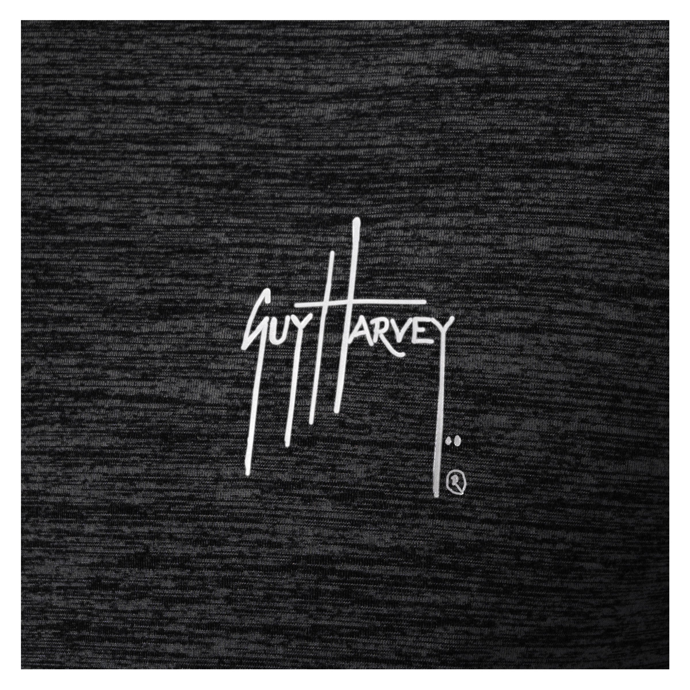 Close-up of white Guy Harvey logo printed on black brushed fleece fabric