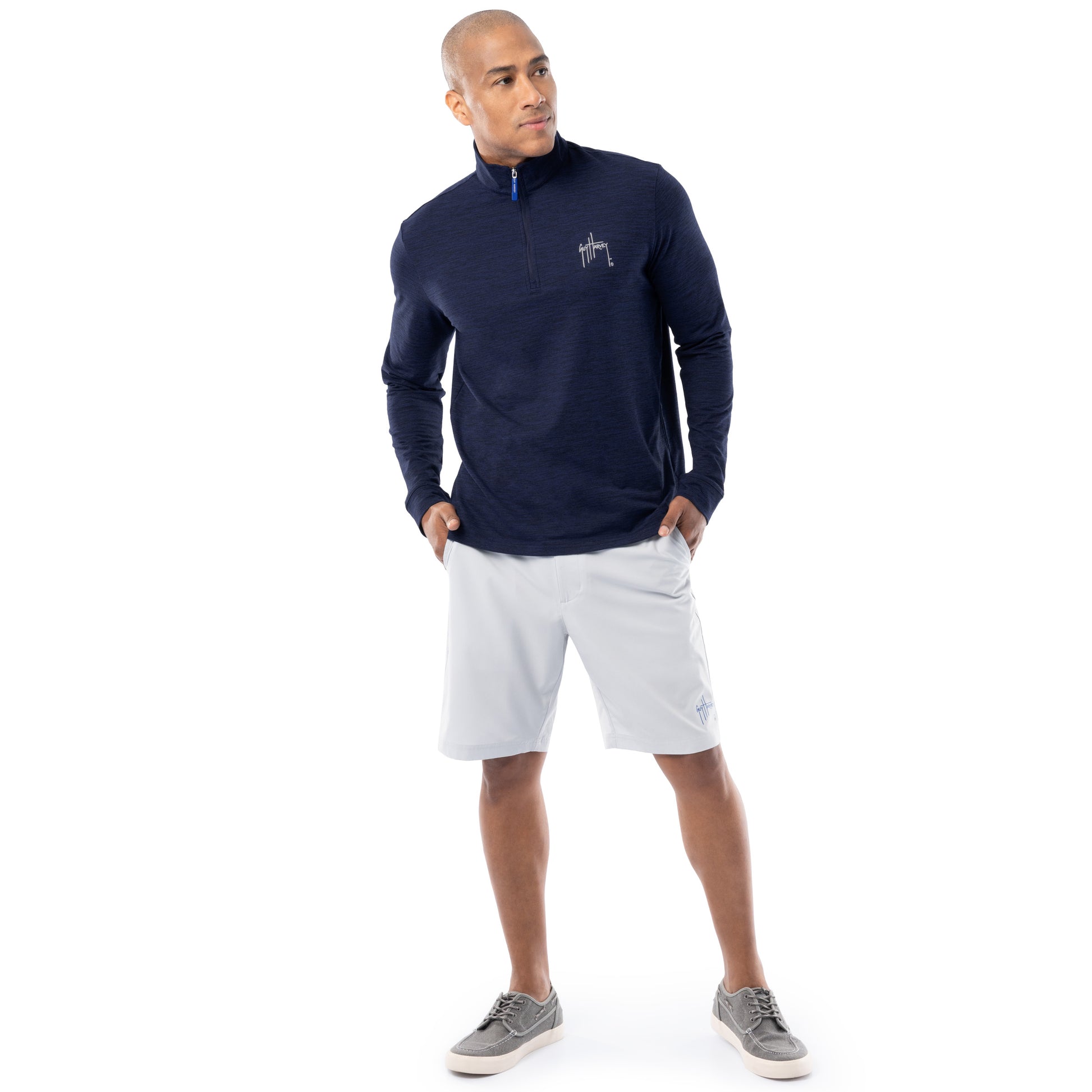 Guy Harvey men’s navy fleece quarter zip pullover styled with light gray shorts, full-body view