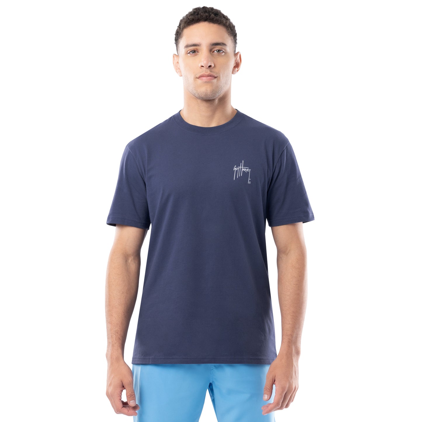 Man wearing a navy blue t-shirt with a logo on a white background