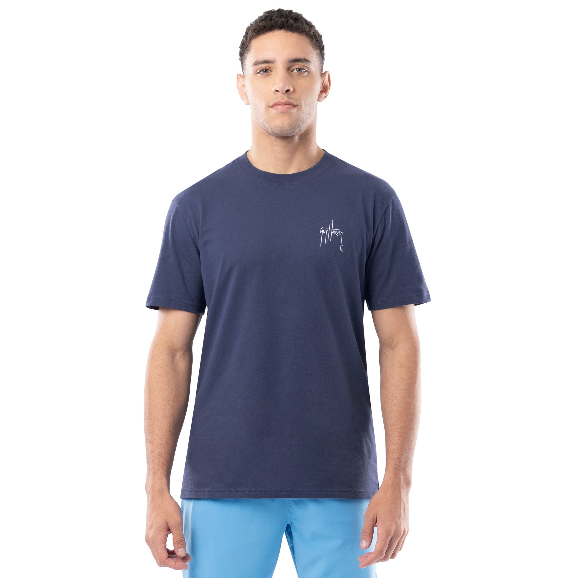 Man wearing a navy blue t-shirt with a logo on a white background