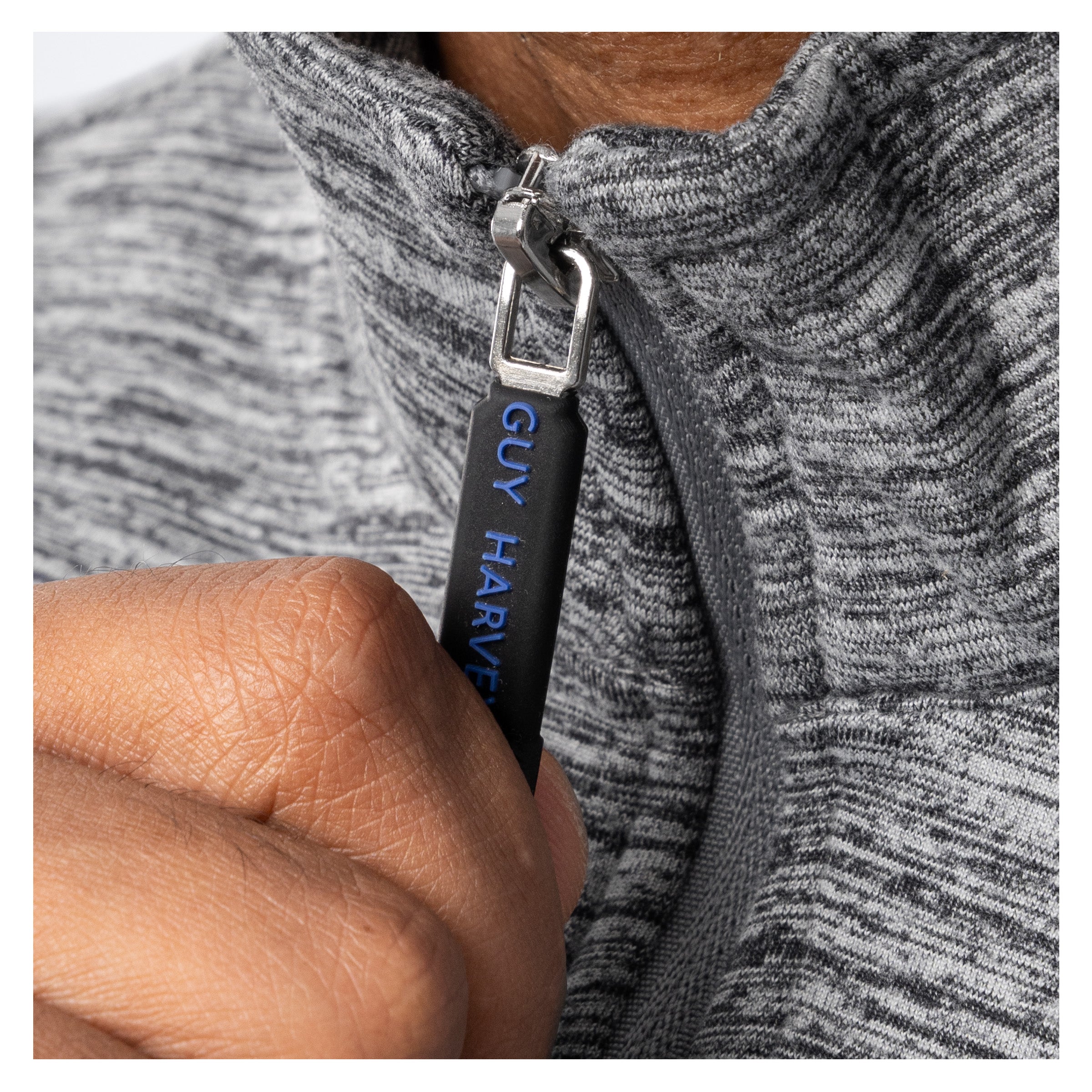 Close-up of Guy Harvey branded zipper pull on heather gray fleece quarter zip pullover