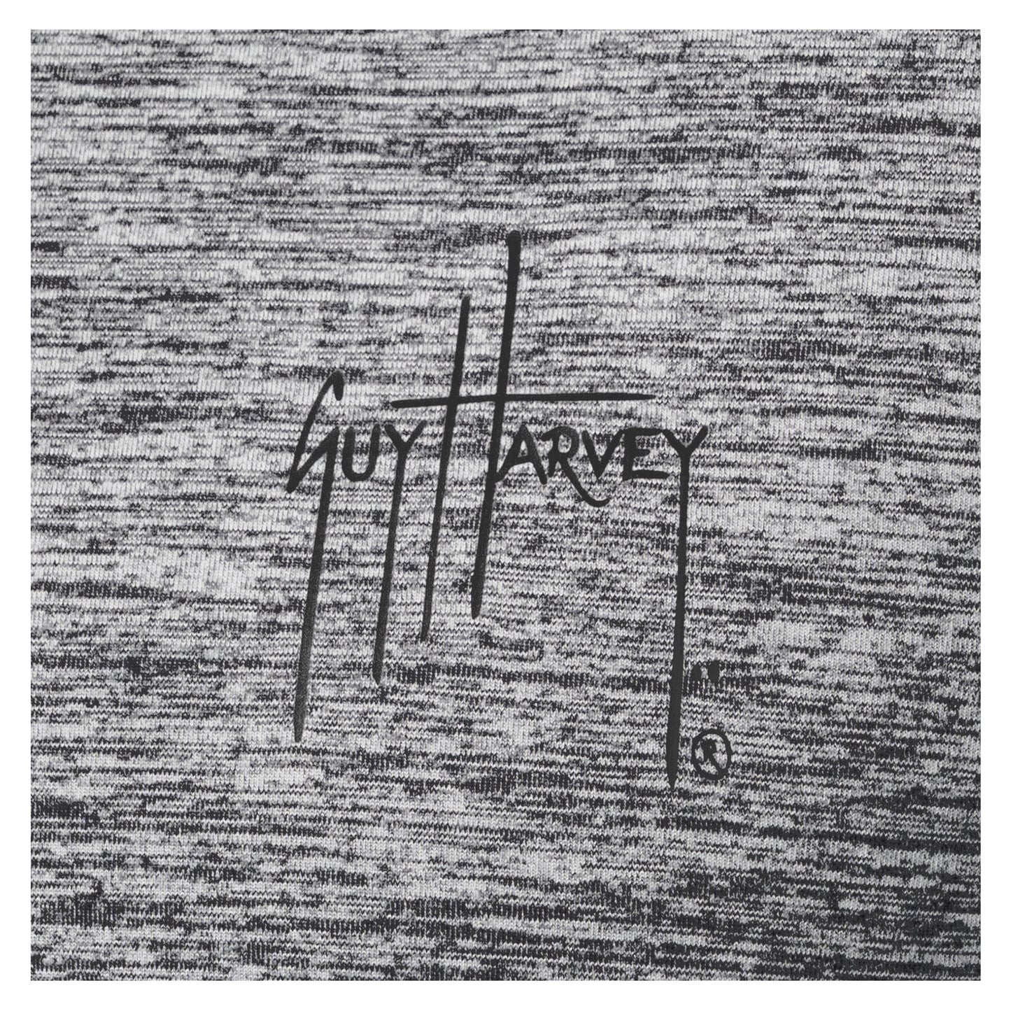 Close-up of black Guy Harvey logo printed on heather gray brushed fleece fabric