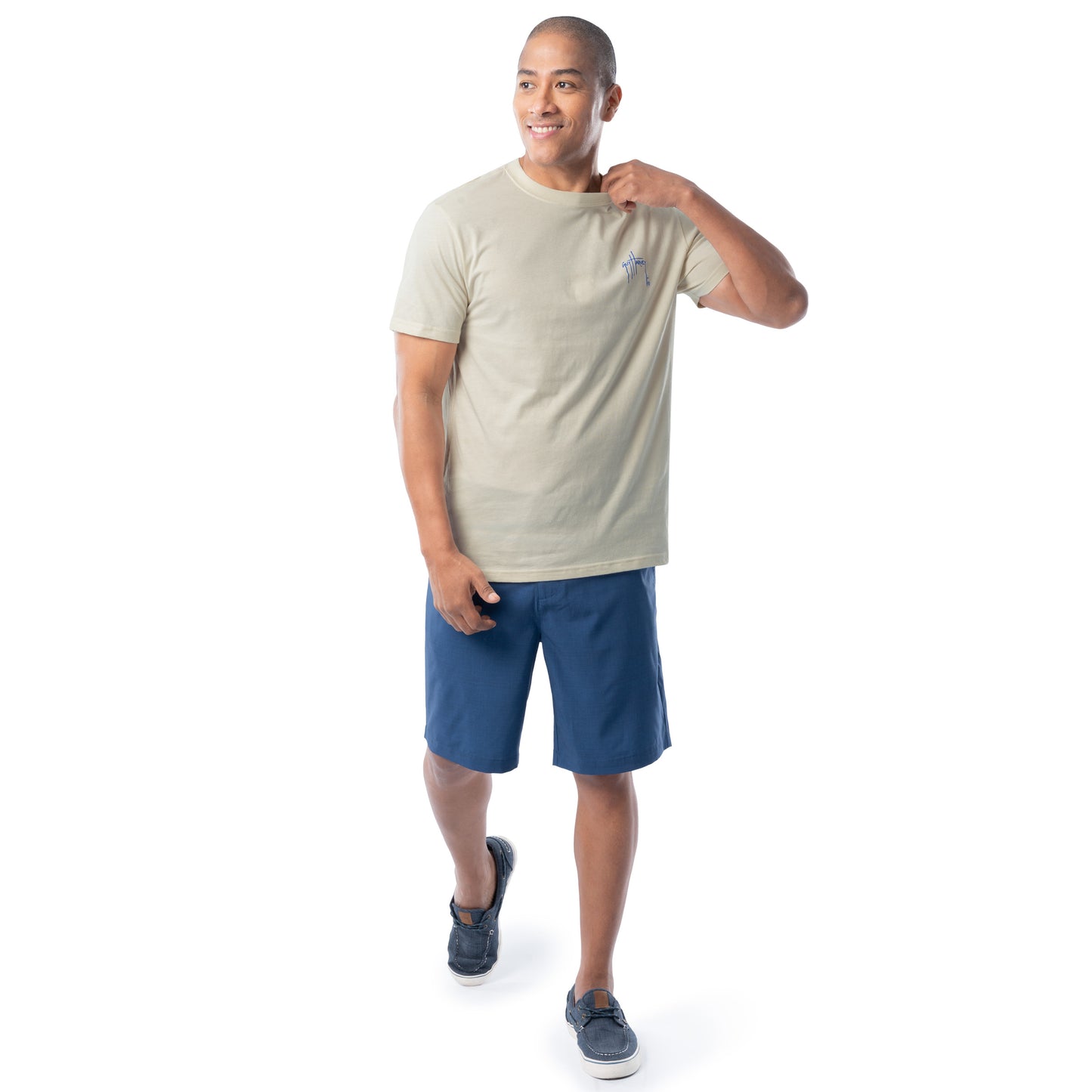 Man wearing a beige t-shirt and blue shorts on a white background