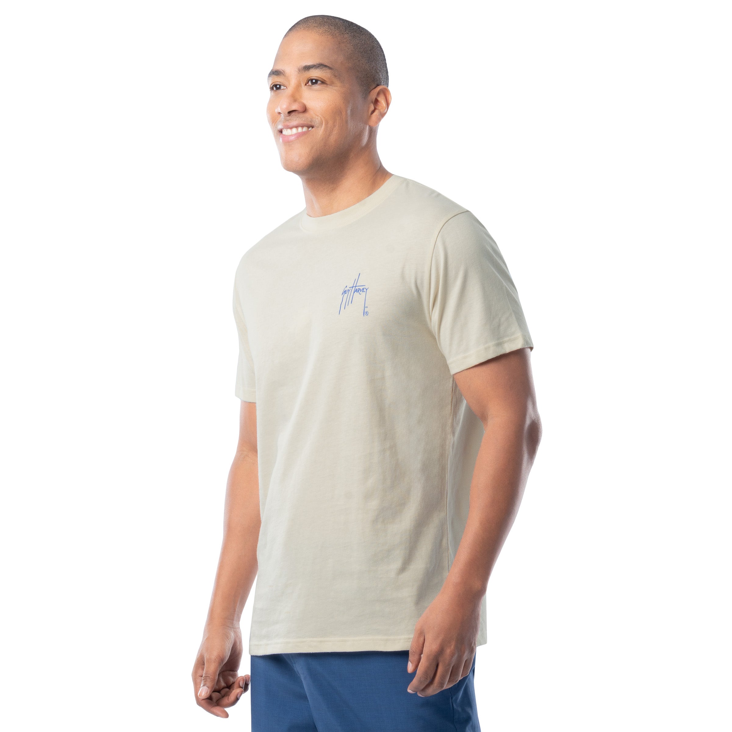 Man wearing a light-colored t-shirt with a small graphic on a white background