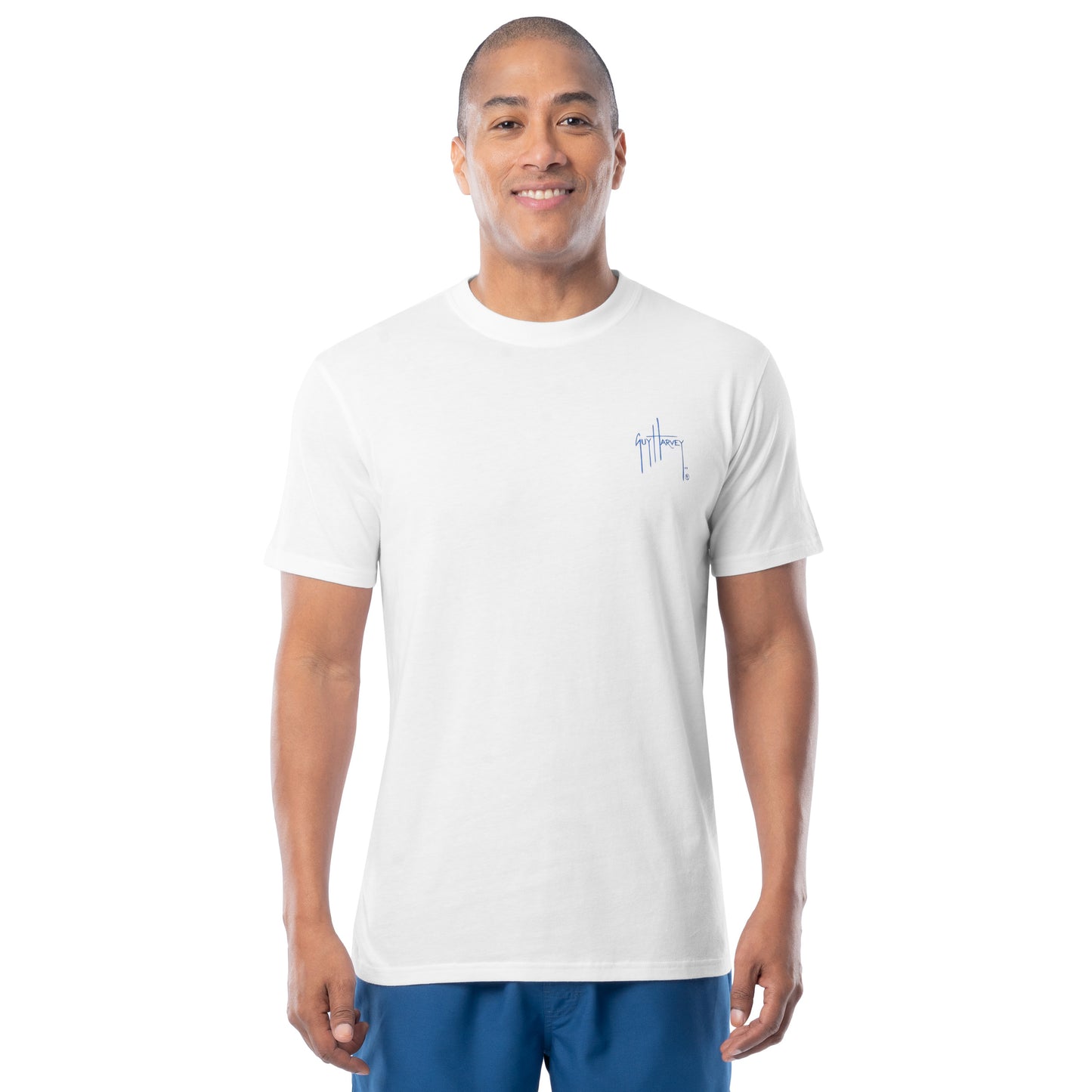 Man wearing a white t-shirt with a left chest Guy Harvey logo on a white background