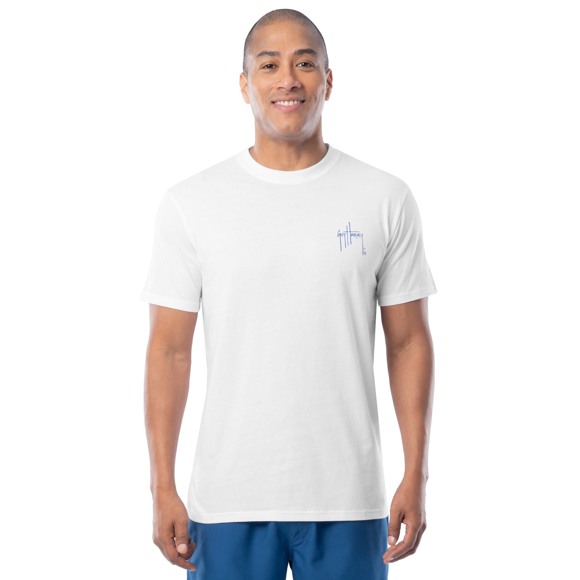 Man wearing a white t-shirt with a left chest Guy Harvey logo on a white background