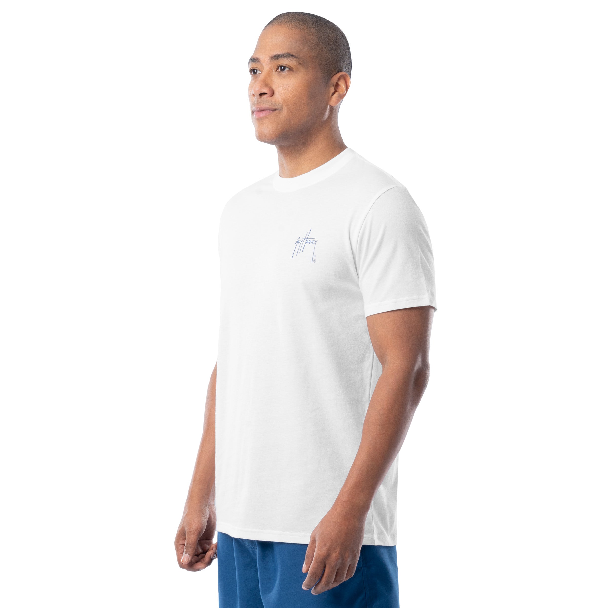 Man wearing a white t-shirt with a small logo on a white background