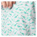Close-up of a shirt with teal fishing lure pattern on a white background