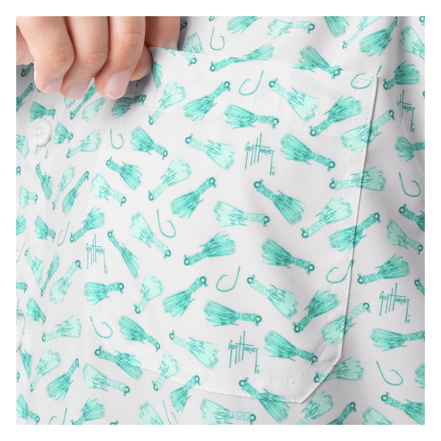 Close-up of a shirt with teal fishing lure pattern on a white background