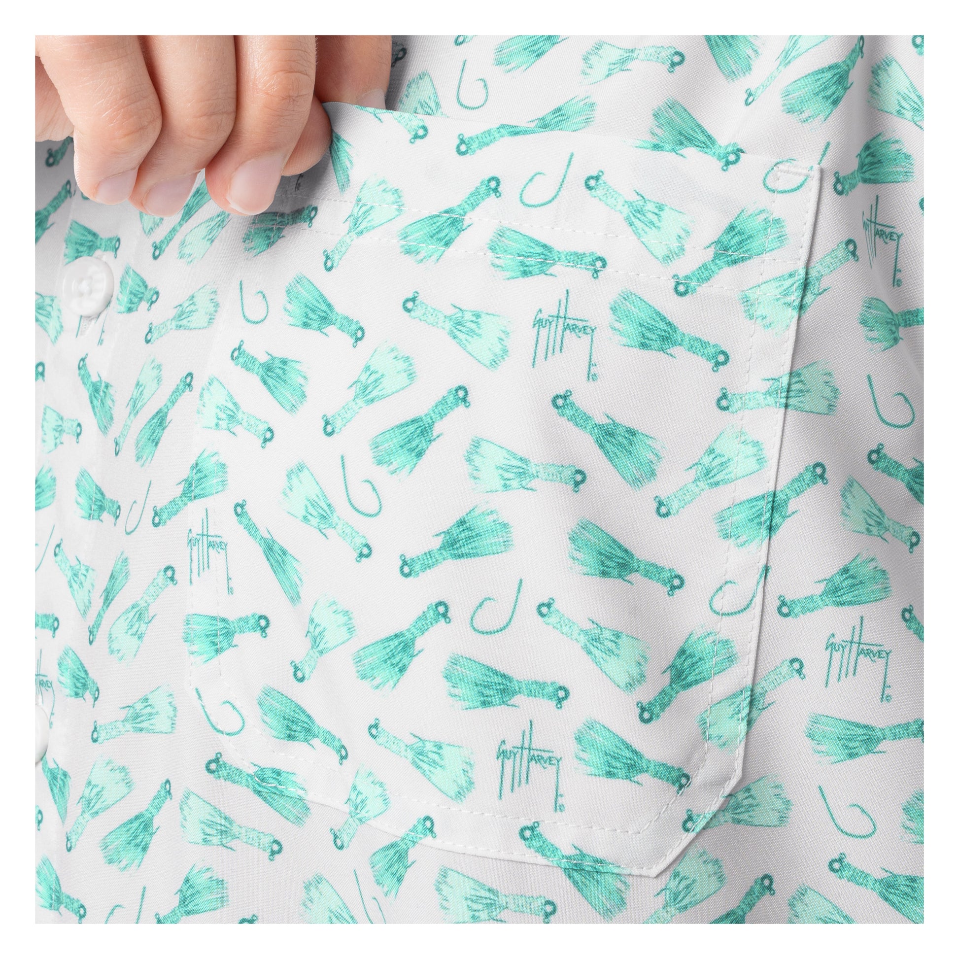 Close-up of a shirt with teal fishing lure pattern on a white background