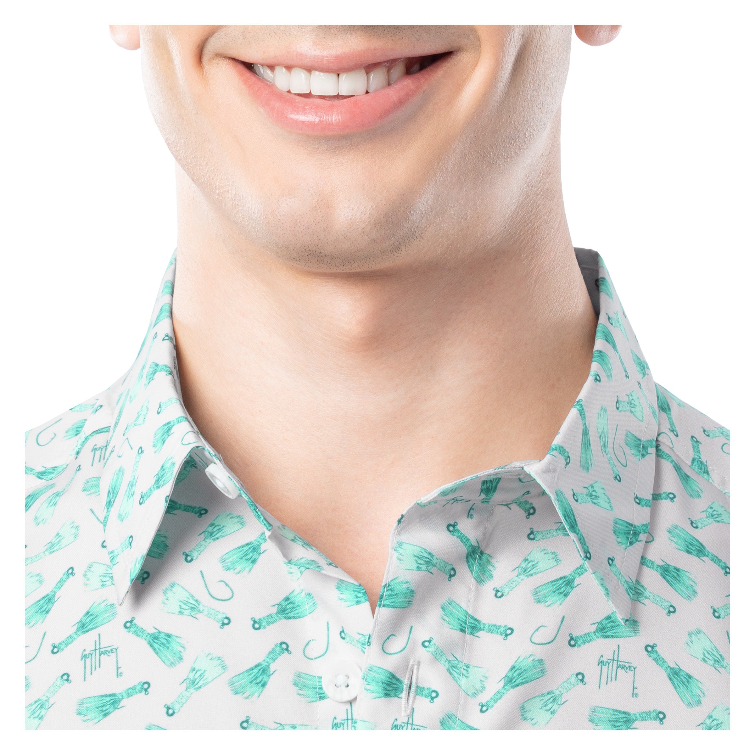 Close-up of a person wearing a shirt with a pattern of fishing-related items.