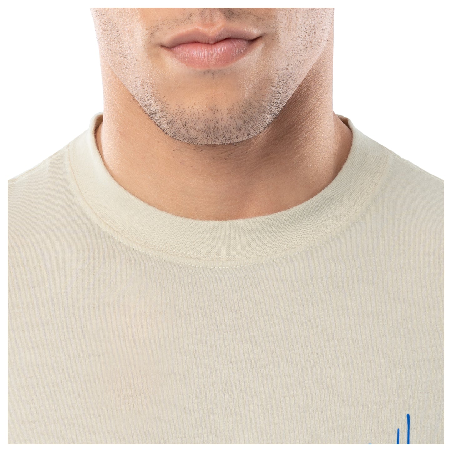 Close-up of a person wearing a beige shirt with a plain background