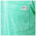 Close-up of a green pocket with a brand label on a garment.