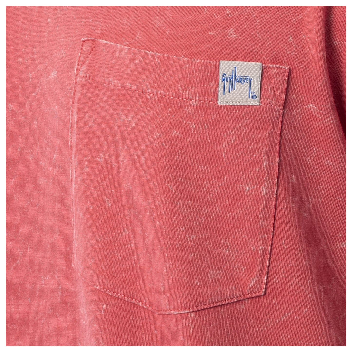 Close-up of a red pocket with a brand label on a red garment