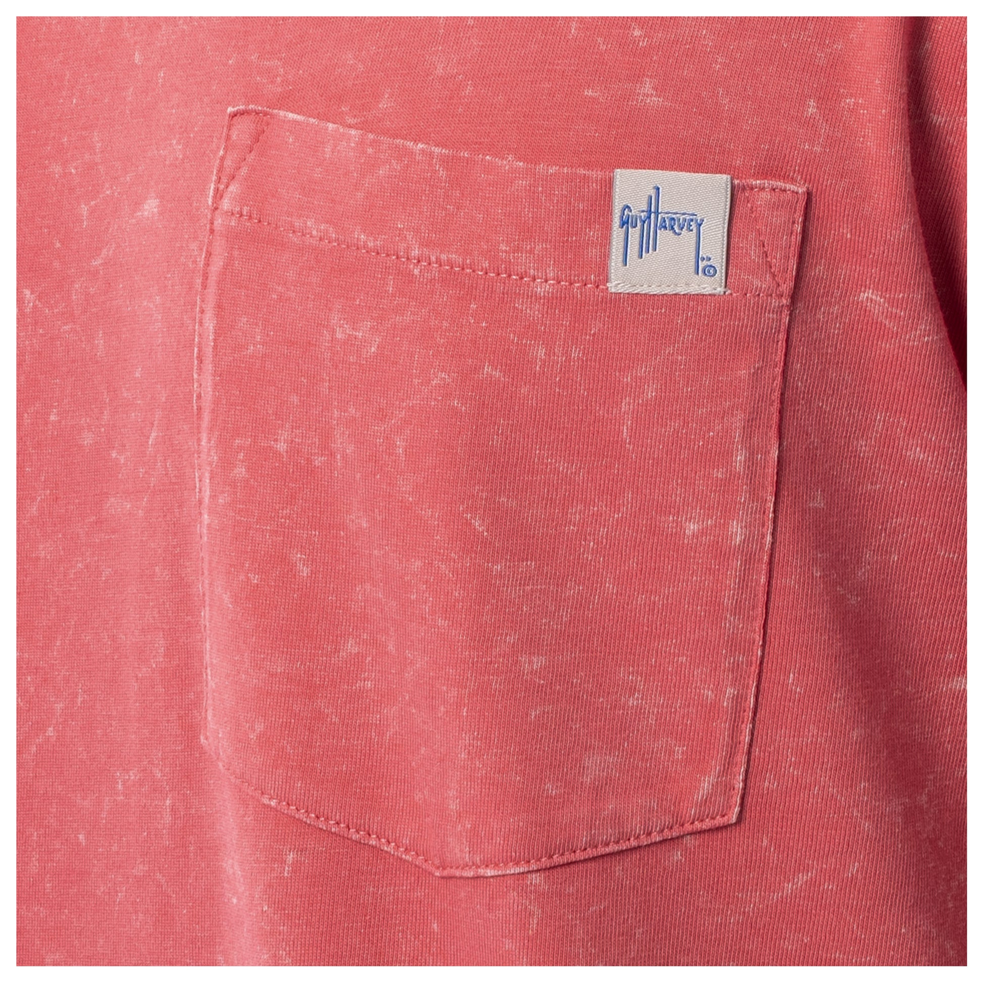 Close-up of a red pocket with a brand label on a red garment