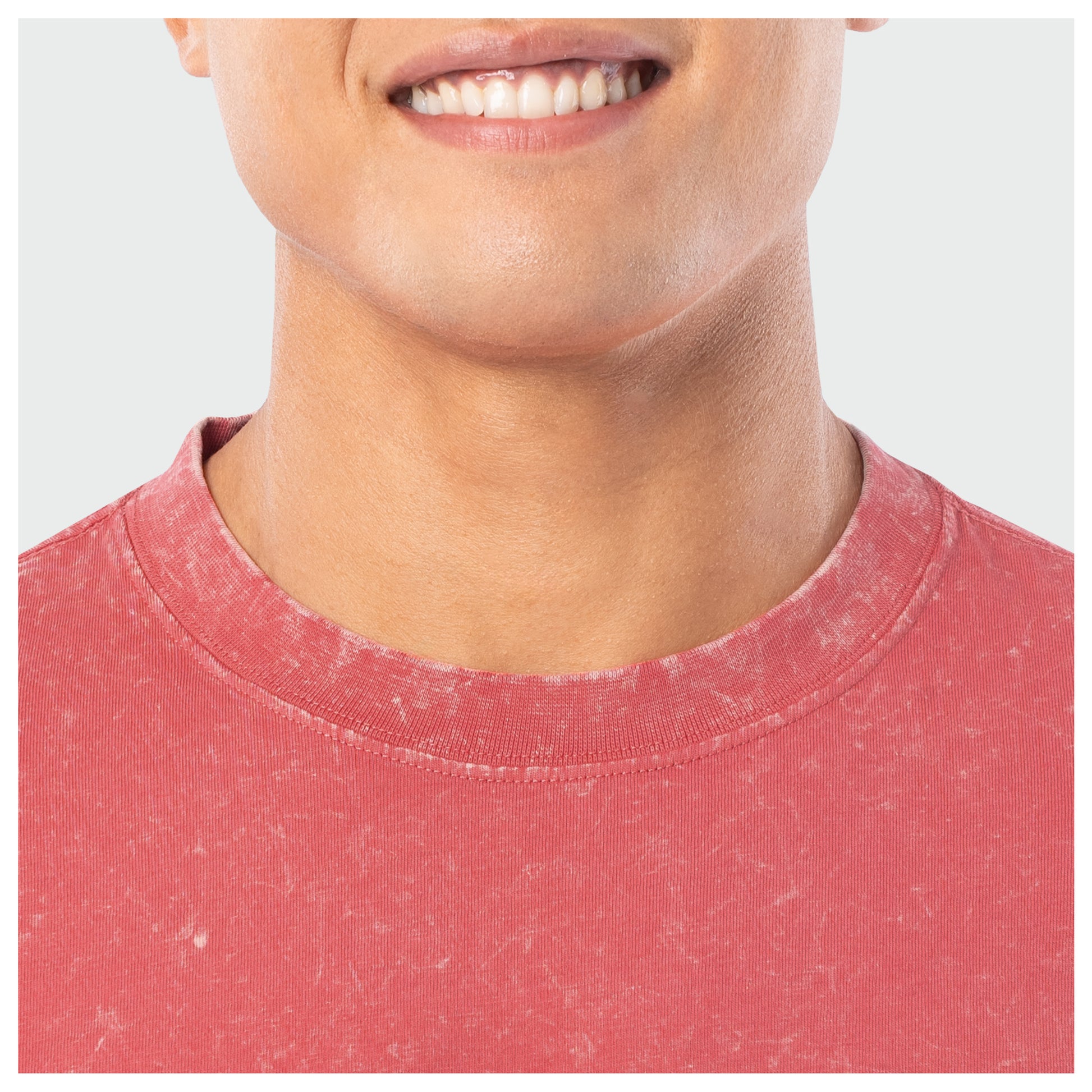 Close-up of a person wearing a red shirt with a plain background